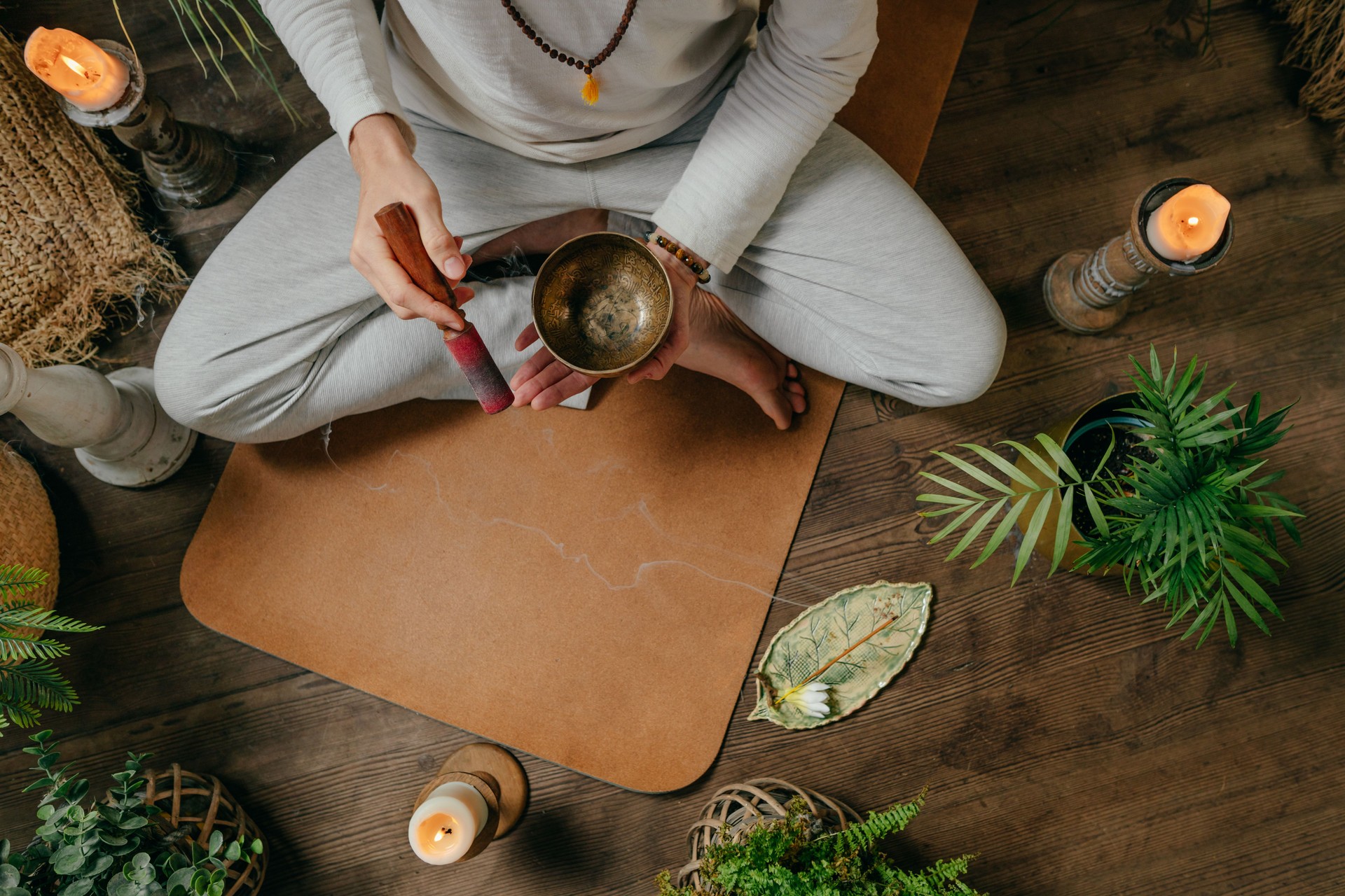 Young man yoga instructor with Tibetan singing bowl